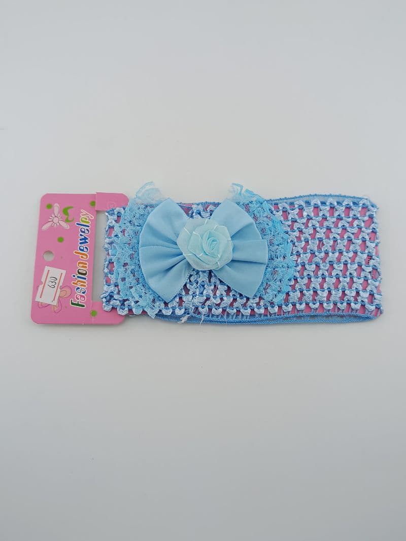 Vincha elástica para cabello azul con lazo y flor decorativa