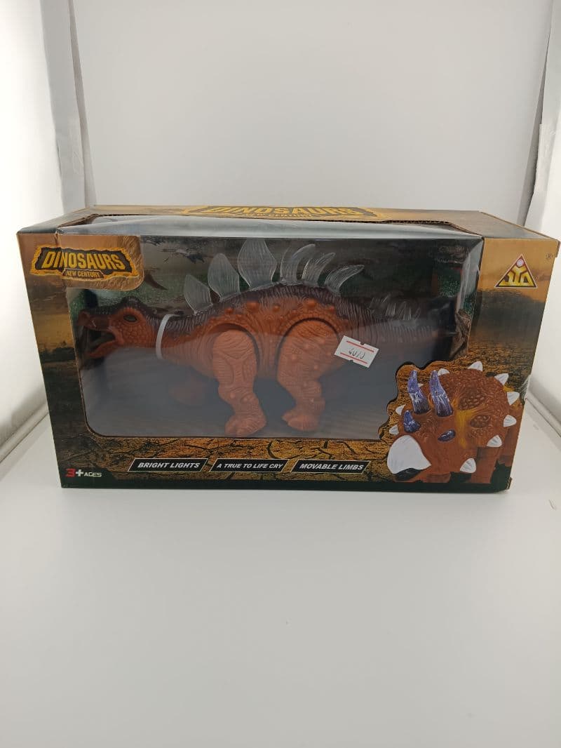 Juguete dinosaurio plástico con luces y sonido en caja